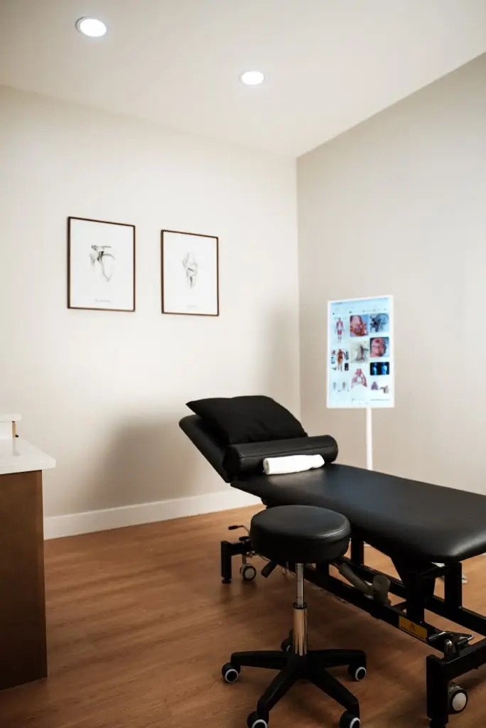 A private treatment room at TRU Physical Rehab, with treatment table and anatomy studies