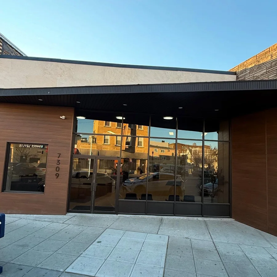 The TRU storefront on Broadway in North Bergen, wood-clad with full-height glass