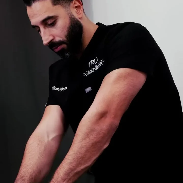 Dr. Hussein Jaafar performing hands-on manual therapy