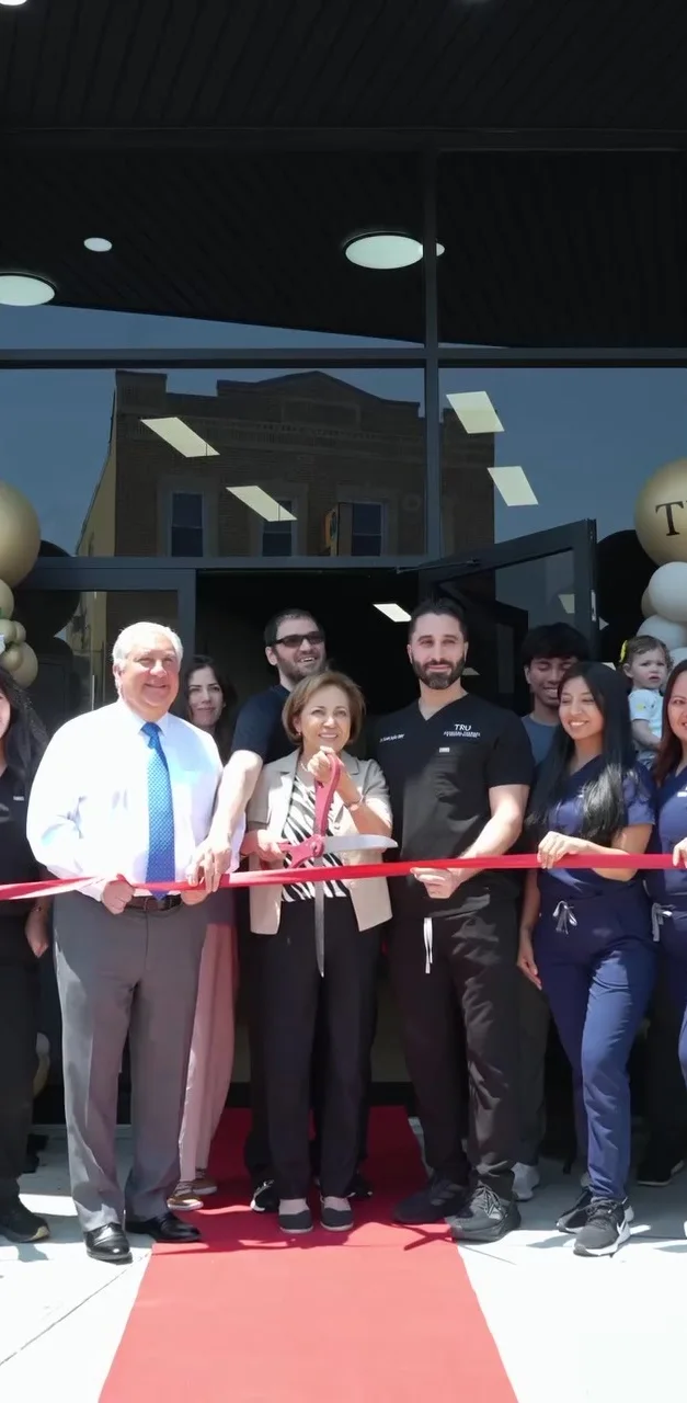 The TRU team and local officials cutting the ribbon outside the North Bergen studio