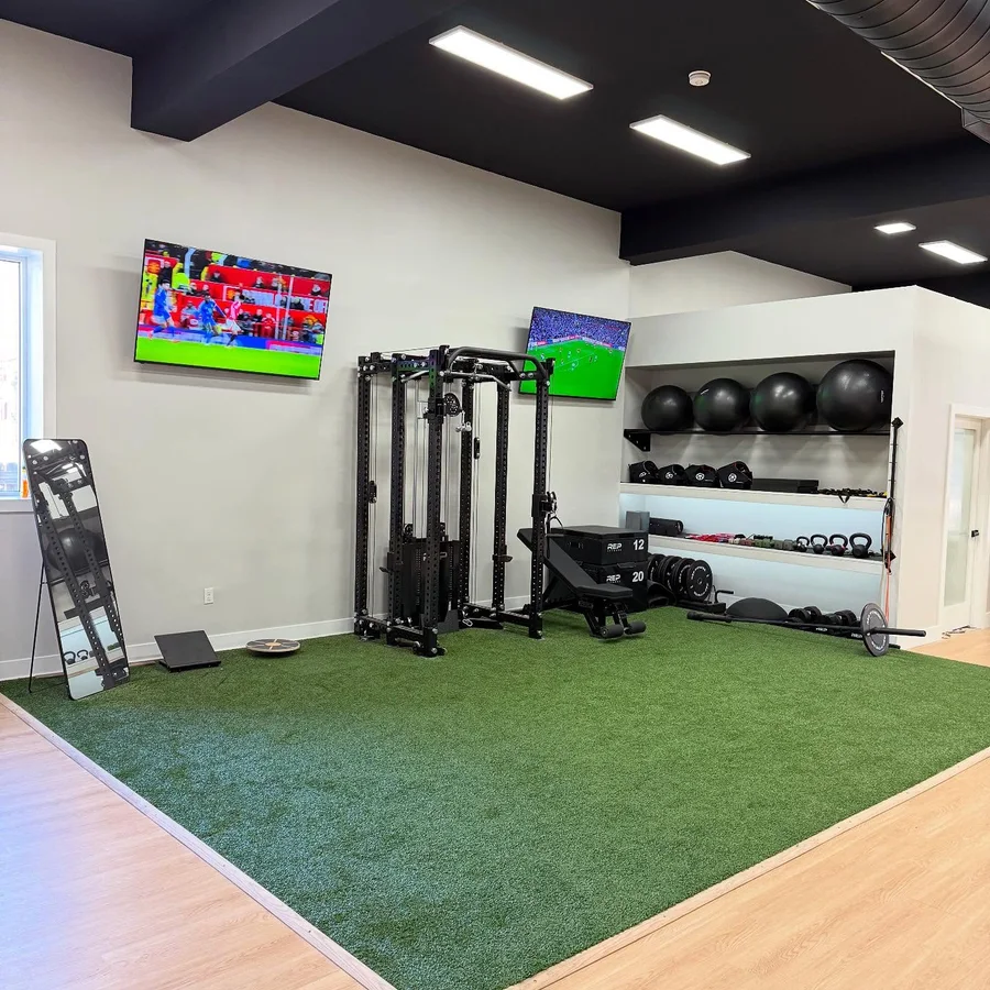 The strength corner: cable rack, medicine balls and turf